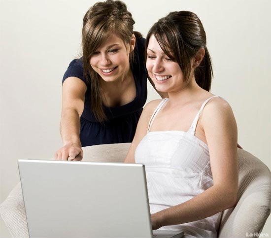 Chicas leyendo noticias en Internet y cotilleando en Facebookl